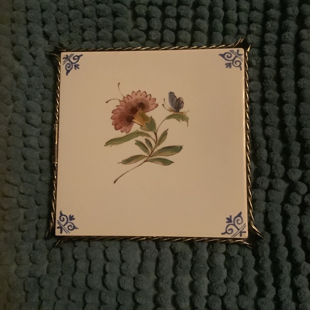 Framed Dutch ceramic tile on a raised intricate metal stand